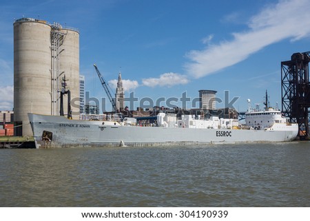 CLEVELAND, OHIO   AUGUST 7, 2015: The 50 year old ship Stephen B. Roman delivers it\'s load of hydraulic cement to the ESSROC plant on the Cuyahoga River in Cleveland, Ohio.