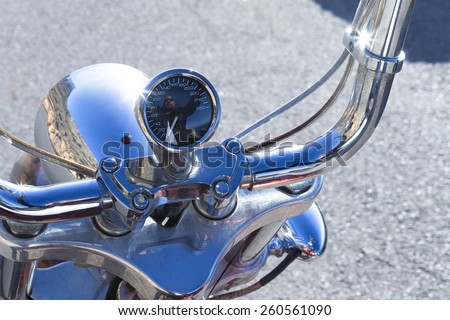 reflection of a chopper motorcycle rider on the motorcycle odometer - focus on the odometer