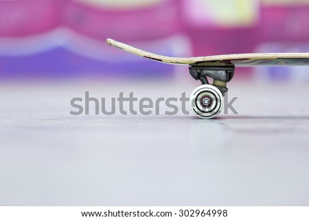 closeup of a part of a skateboard at the skate park useful as a background - focus on the wheel