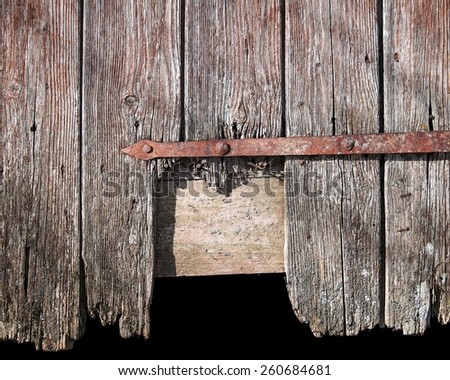 Broken door of a wooden barn