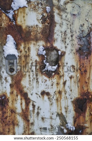The background texture. Rusty metal on a white trailer, winter