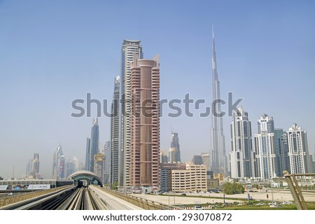 DUBAI,UNITED ARAB EMIRATES - 16 JUNE 2015 : Skycrapers in modern centre of Dubai with metro railways,Dubai,United Arab Emirates