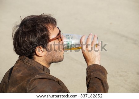 MILANO ,ITALY -16 October 2015 : a man drinking a glass of traditional beer at a public event on the road