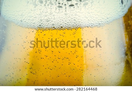 close up shot of beer bubbles frost glass