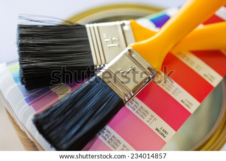 home improvement - painting walls with brushes and variety of colors