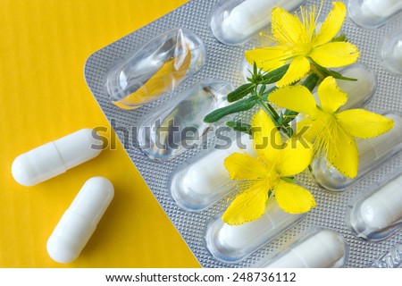 common St. John\'s wort -  hypericum perforatum - natural antidepressants - pill and yellow flowers with leaves