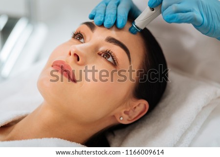 Hydrafacial procedure. Close up of a face of a nice beautiful woman during hydrafacial procedure