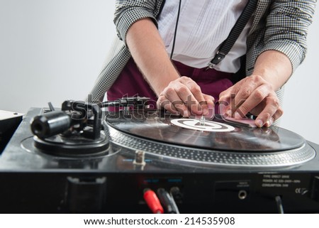 Close up view of DJ with playing cards on mixer and standing isolated on white background