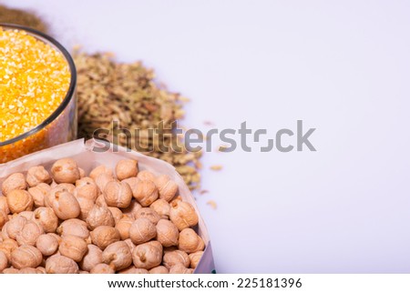 Composition of glasses with cereals like buckwheat maize rice peas haricot millet oats beans poppy seed herbage noodles isolated on white background with copy place