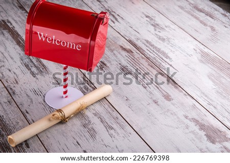 Christmas decoration like pillar box with title welcome and letter in bundle on wooden  table top view with copy place