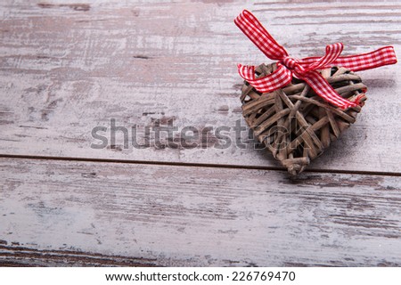 Christmas tree toy and  decoration like wicker wooden heart with red checked  bow on table top view with copy place