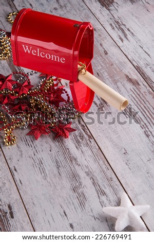 Christmas tree decoration like silver or golden beads and red pillar box with letter in bundle and white star  on wooden  table top view with copy place