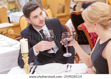 Couple at the restaurant. Closeup shot of a beautiful young couple drinking wine at the restaurant