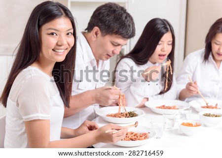 Family lunch.  Asian family at having modern lunch together