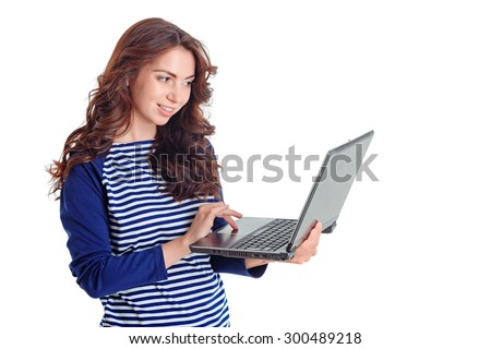 Lets chat. Nice pretty young girl holding laptop and looking at it while having pleasant conversation online.