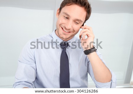 Glad to hear you. Blissful cheerful call center operator holding mobile phone and talking on it while feeling delighted.