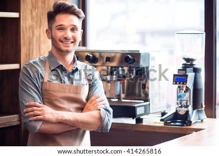 Pleasant waiter  working in the cafe