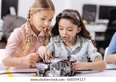 Surprised young scientists having tech class at school