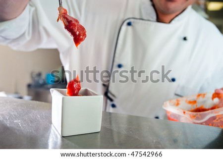 Chef fills gravy boat