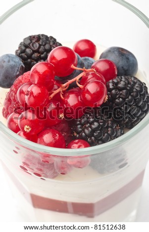 Panna cotta with Fresh forest berries in a glass on a white background isolated, Italian dessert