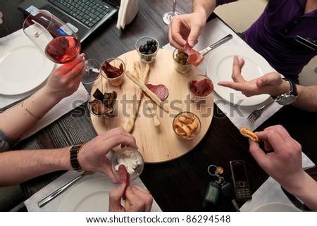 Business lunch - Group of people eating lunch of a set of delicious spicy snacks