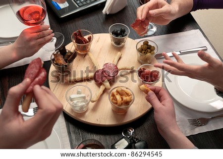 Business lunch - Group of people eating lunch of a set of delicious spicy snacks