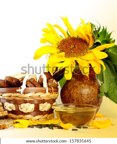 Yellow sunflowers and sunflower seeds on a white background
