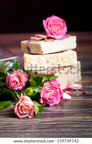 Spa Settings with roses and salt in bowl , towel. Candle,soap on straw mat