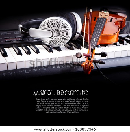 Violin, piano keys and headphones on black