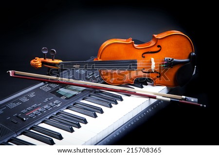 Violin and piano keys on black
