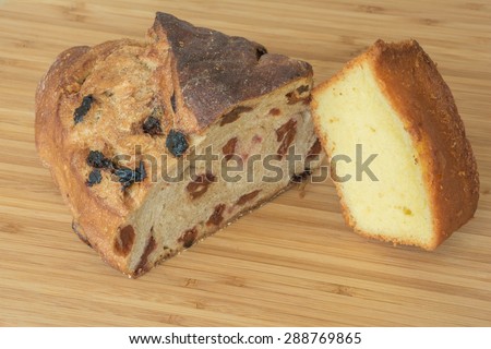 Loaf of cherry bread and lemon cake of gourmet baking for snack on wood board