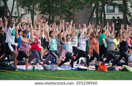 New York City, New York, USA; 09 July 2015: People participating in the free public Yoga class on Thursday evenings in summer at Bryant Park, New York City.