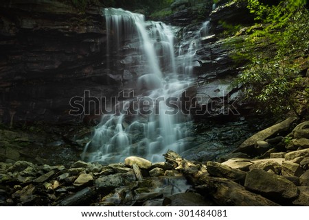 Motion blur of cascading tall water fall over rocks at Glen Onoko Falls hiking trail
