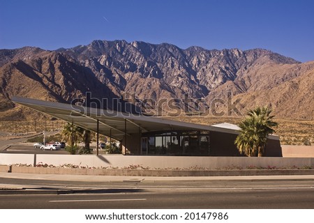 Palm Springs Visitor Center (the old Tramway Gas Station) a classic example of Desert Modern architecture with the San Jacinto mountains in the background and reflection in the glass.