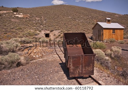 View of an ore cart and the entrance to Diana Mine at Berlin Ghost Town in Nevada from Berlin Ichthyosaur State Park outside of Reno