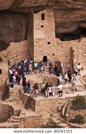 MESA VERDE NATIONAL PARK, CO - JUNE 19: A tour group visits the Cliff Palace ruin on June 19, 2011 at Mesa Verde National Park in Colorado.  Rangers lead guided tours of these famous ruins during the summer.