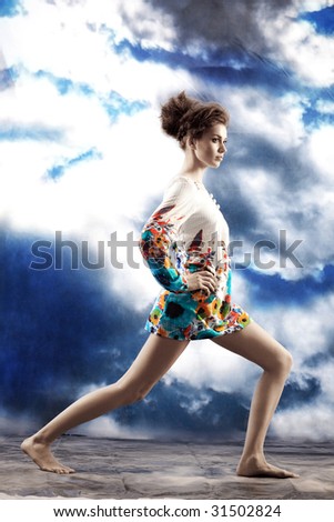 The woman in studio against with clouds
