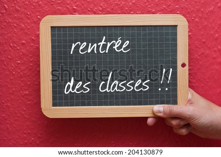 Chalkboard in hand - back to school -text in french