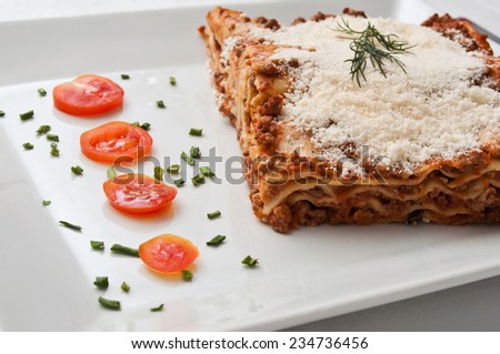 lasagna with cherry tomatoes presentation in a plate