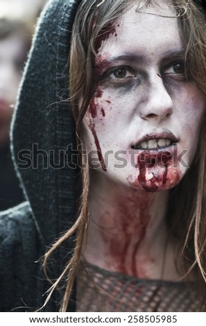 Paris, France - November 16, 2010: People dressed as a zombie parades on a street during a zombie walk in Paris.