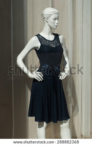 mannequin with a blue dress in a showroom