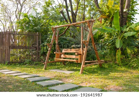 Wood swing bench in a park