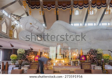 Udonthani, Thailand- March 21,2015: Main chapel of Wat Pa Phu Kon, Buddhist cleaning pad in front of the biggest white marble nirvana Buddha in Thailand, 20 metres long