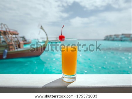 Orange juice and fresh cherry and sea view on water villa, Maldives