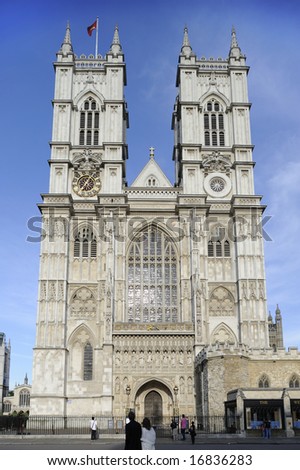 The front facade and towers of Westminster Abbey, London, UK, just as the sun is getting low in the sky.