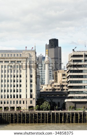 Monument to the Great Fire of London, England, UK, Europe, enclosed by modern office buildings, with Tower 42 in the background, looking over the River Thames