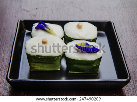 Thai pudding with coconut topping . Thai dessert made of flour, sugar, coconut milk, and other flavoring ingredients such as corn or taro. Traditional dessert of Thailand.