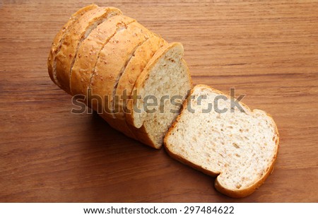 fresh home made whole wheat bread on the wooden background. sliced bread on wood background. Top view of bread on wood table.