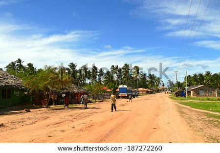 LINDI, TANZANIA - DECEMBER 2, 2008: the Village. Strangers villagers go about their business in Lindi, Tanzania - December 2, 2008. Truck on the road. Residential houses around.