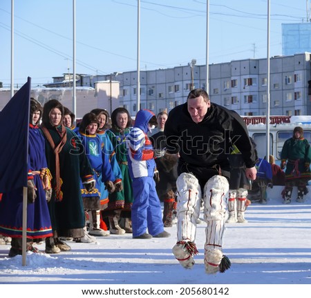 Nadym, Russia - March 15, 2008: the national holiday - the Day of the reindeer herder in Nadym, Russia - March 15, 2008. Sports competitions. Unknown man jumps over obstacles.